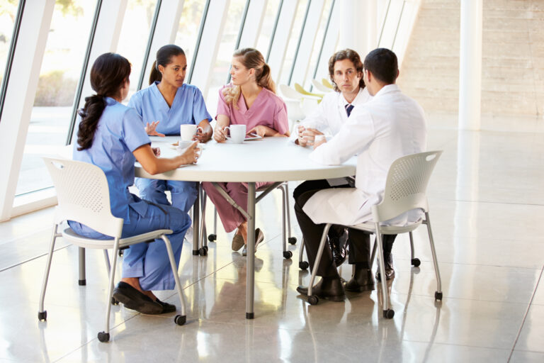 Medical Staff Chatting In Modern Hospital Canteen